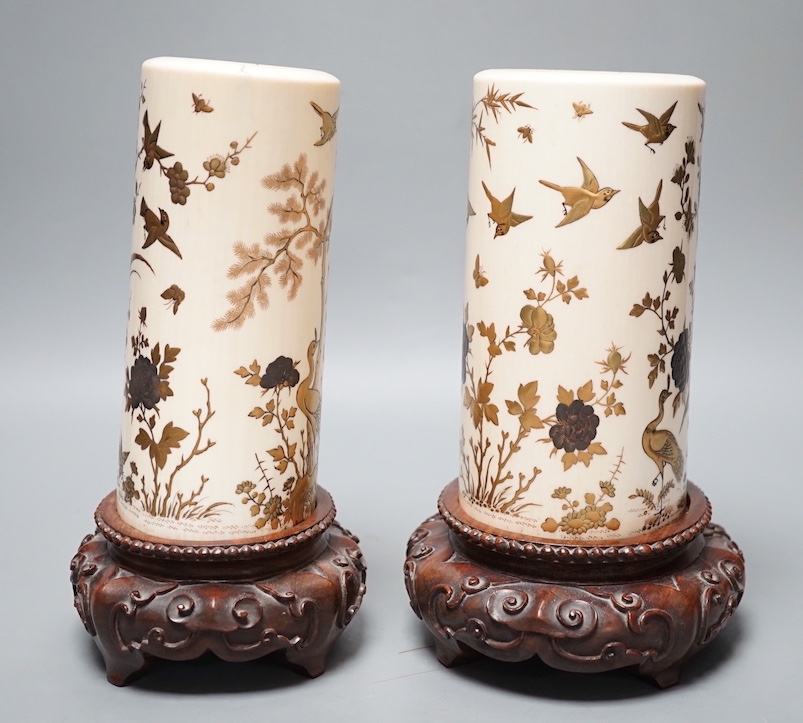 A graduated set of two Japanese gilt lacquered ivory vases, Meiji period, wood stands. Total height 21.5cm